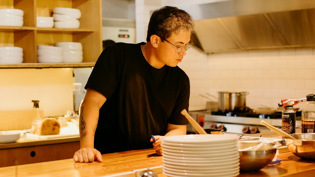 A man standing in a kitchen preparing food