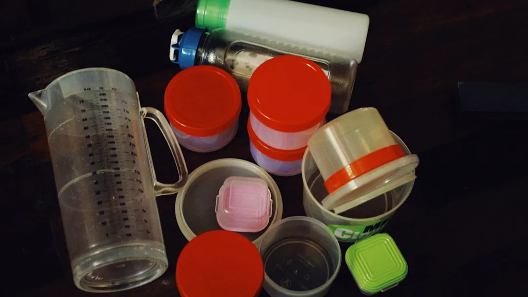a table topped with plastic containers and containers