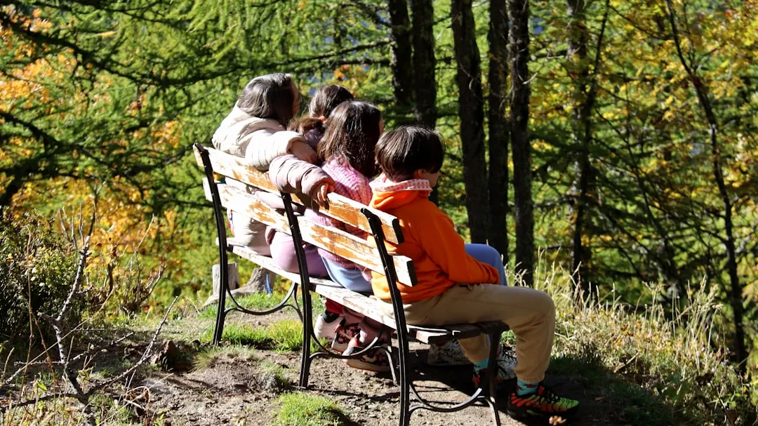 Family sitting on a bench in a forest