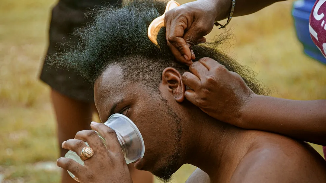man drinking water from bottle