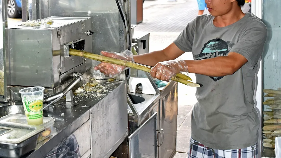 man wearing gray crew-neck t-shirt standing near gray stainless steel oven