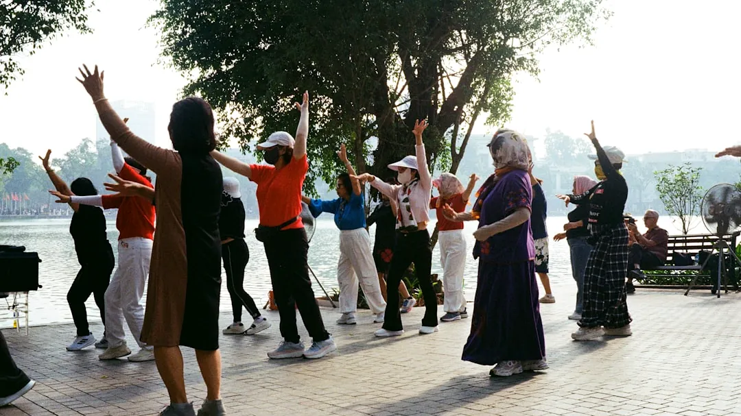 People exercising outdoors by a lake