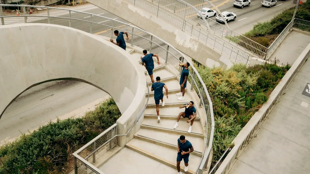 People run up a concrete staircase.