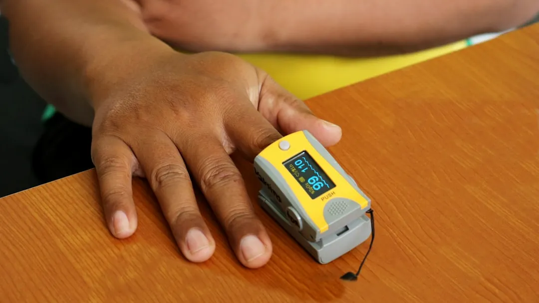 person holding white and blue plastic container