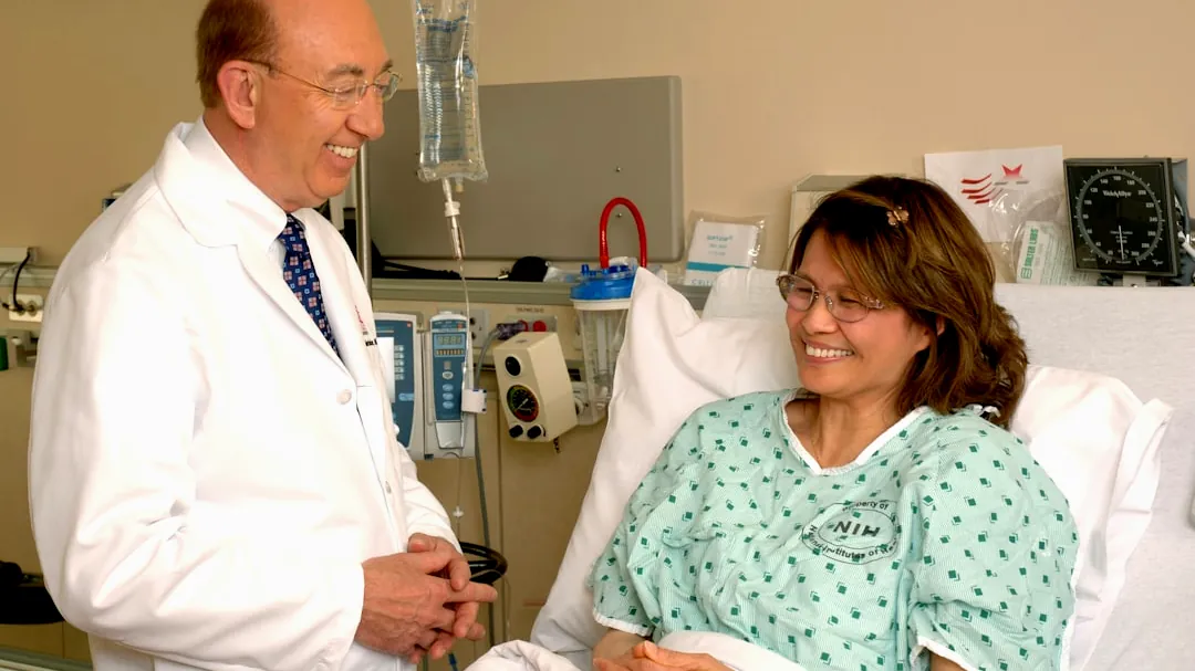 woman in teal scrub suit sitting beside man in white medical scrub suit