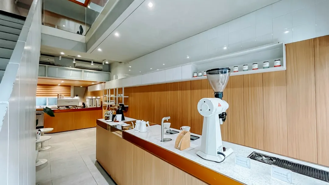 A kitchen with a counter, sink, and stairs