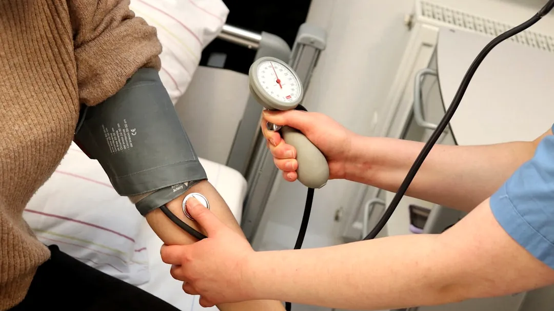 A person with a blood pressure device in their hand