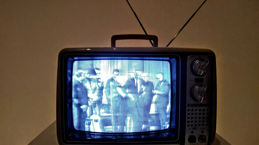 black crt tv turned on on white table