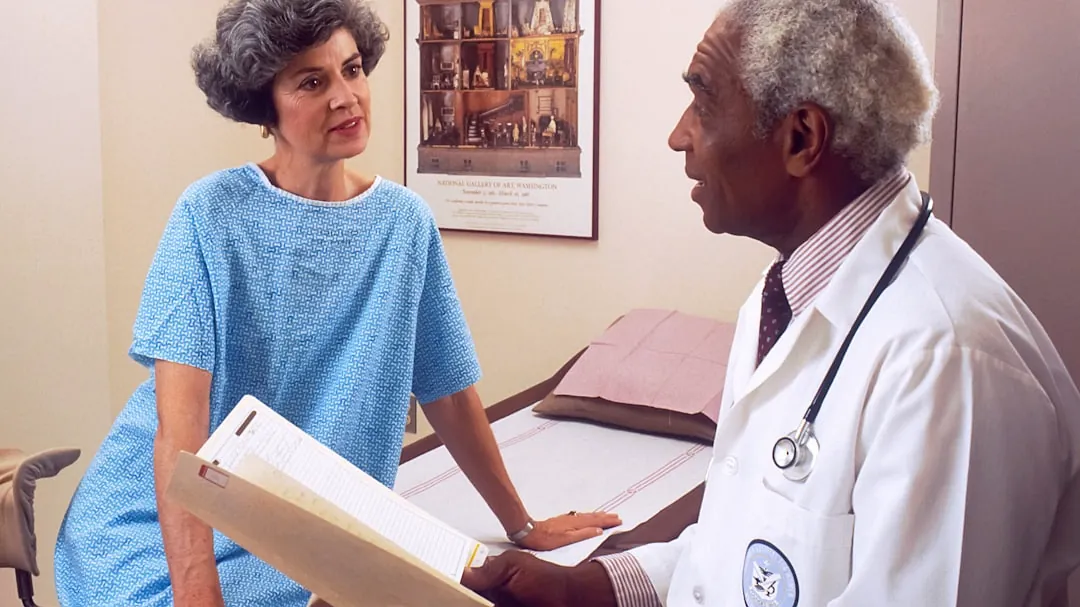 man in blue crew neck t-shirt holding white printer paper