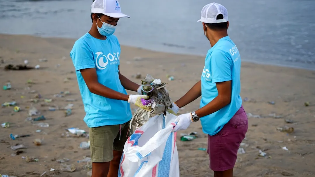 man in blue crew neck t-shirt holding white textile