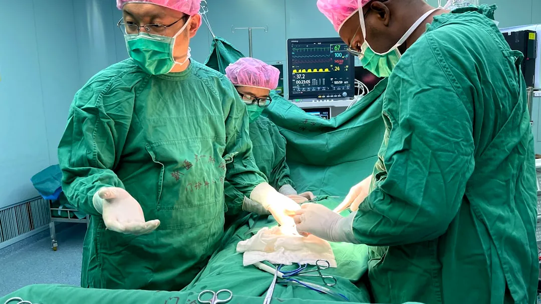 Surgeons performing a medical operation in an operating room.