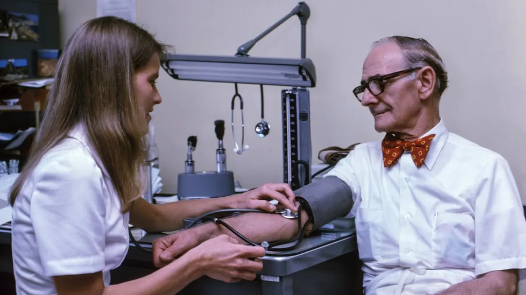 a doctor examining a patient's ankle with a stethoscope