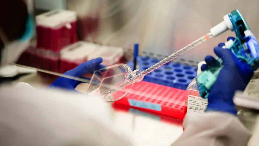 a person in a lab holding a pipe
