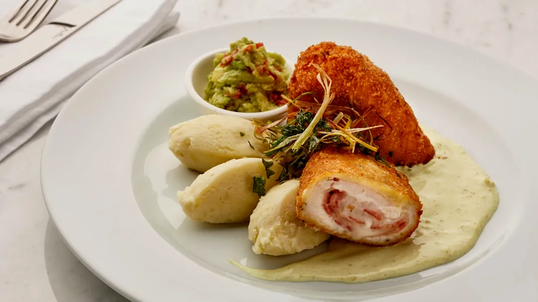 a white plate topped with meat and potatoes