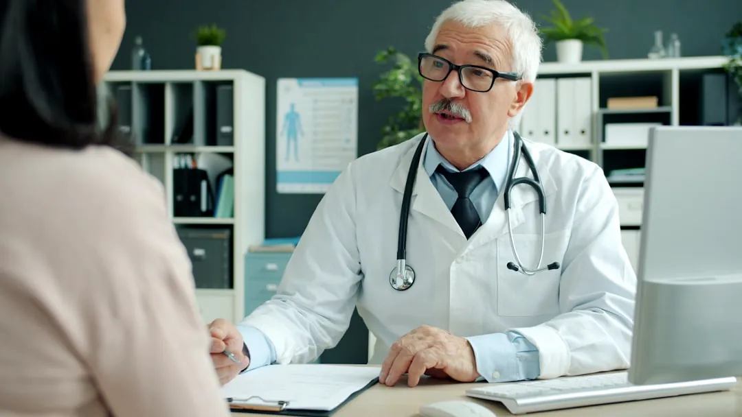 Doctor talking to patient in an office.
