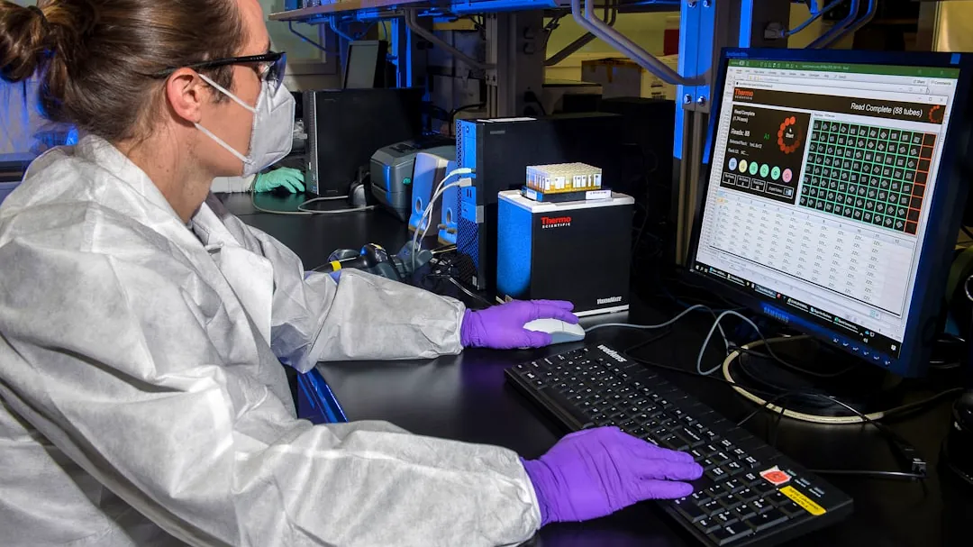 man in white dress shirt sitting in front of computer