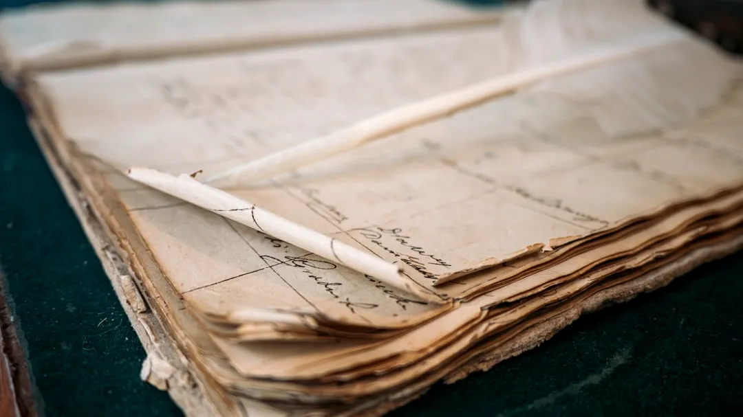 A close-up of an old, open ledger with handwritten notes.