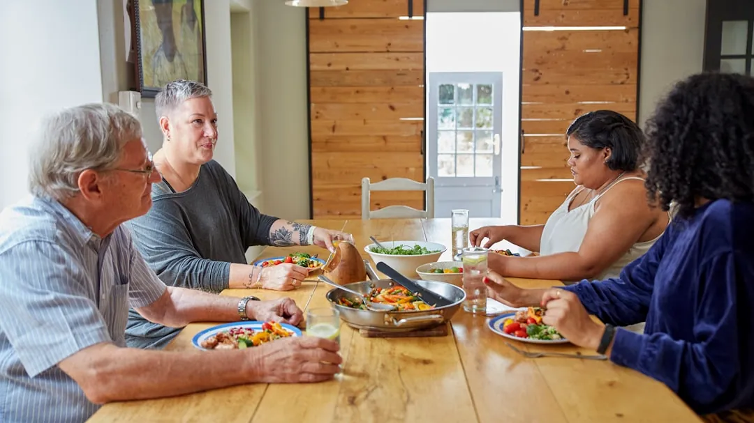 a group of people sitting around a table eating food